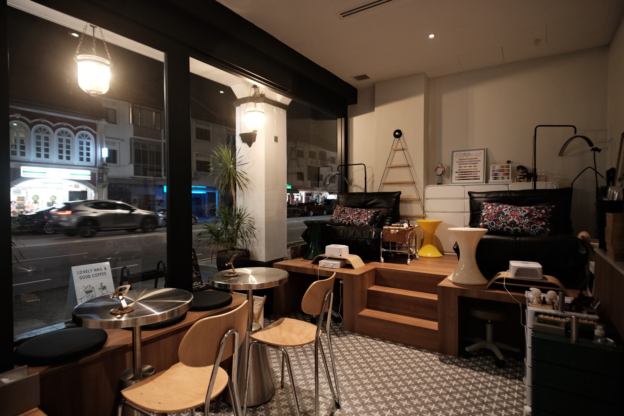 Window bar seating with heritage pendant lamps in a manicure café Singapore