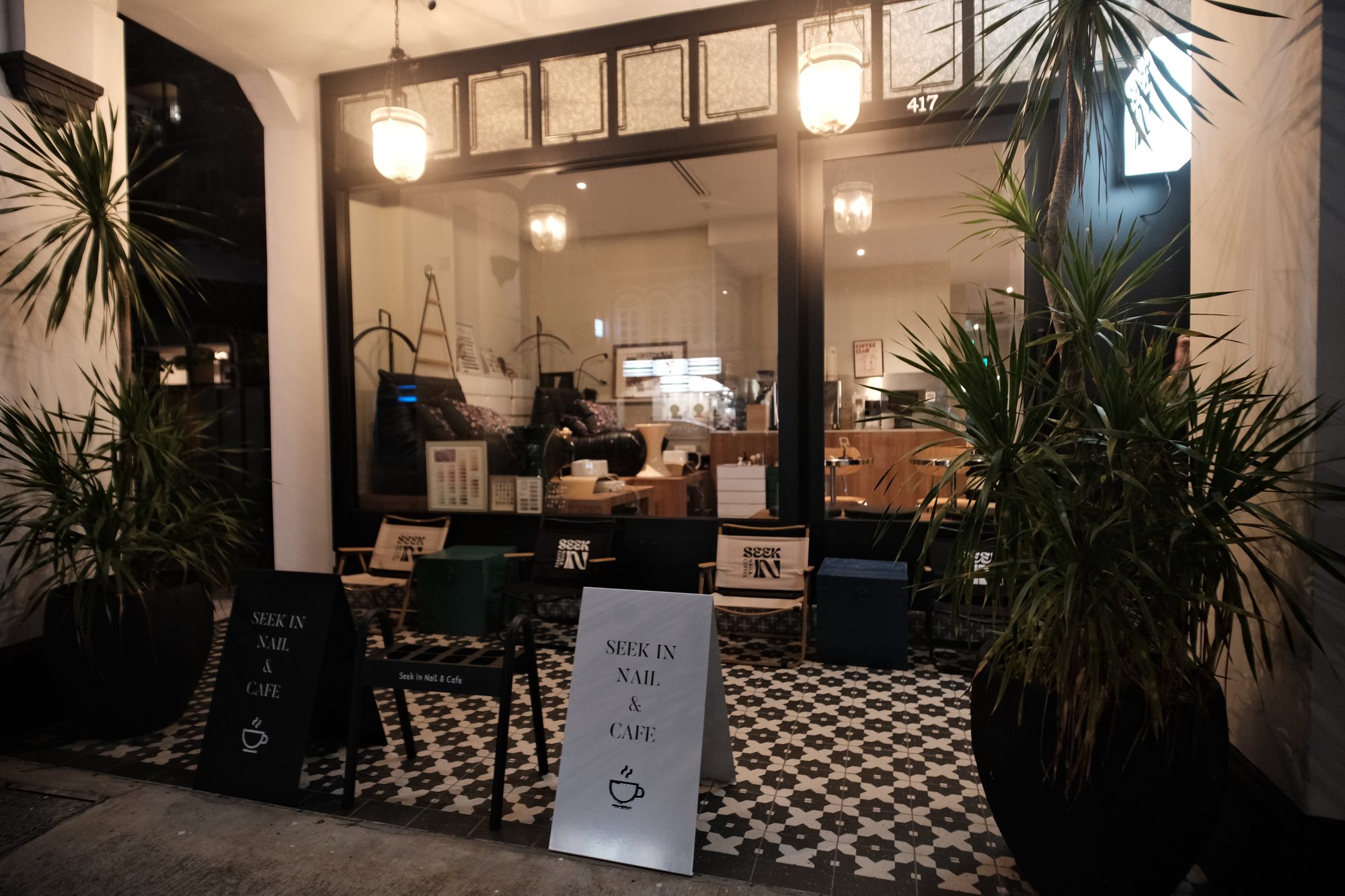 Nail bar and café interior with encaustic floor tiles and warm lighting Singapore