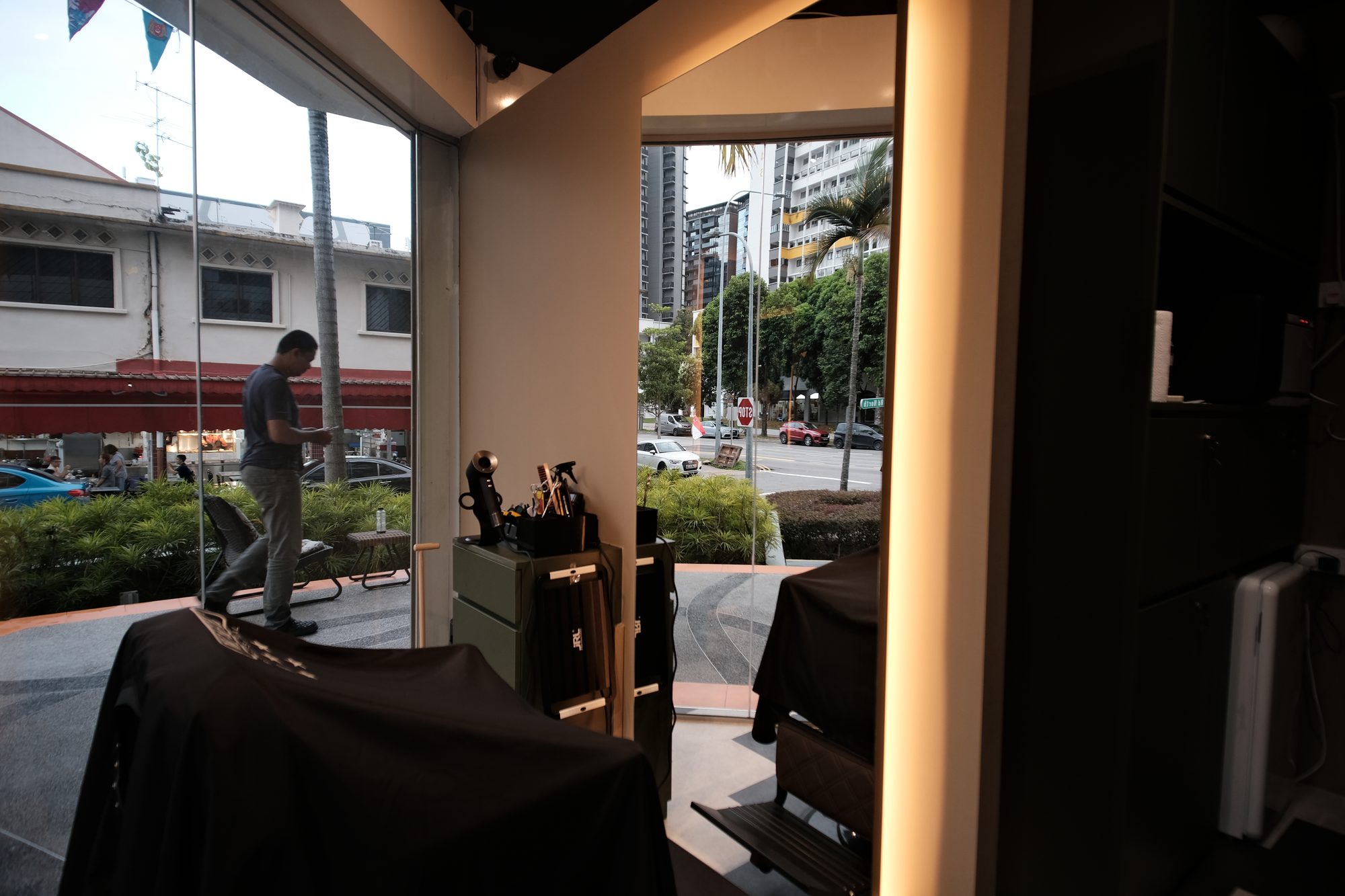 Barber chairs set against a glazed shopfront in a compact commercial unit Singapore