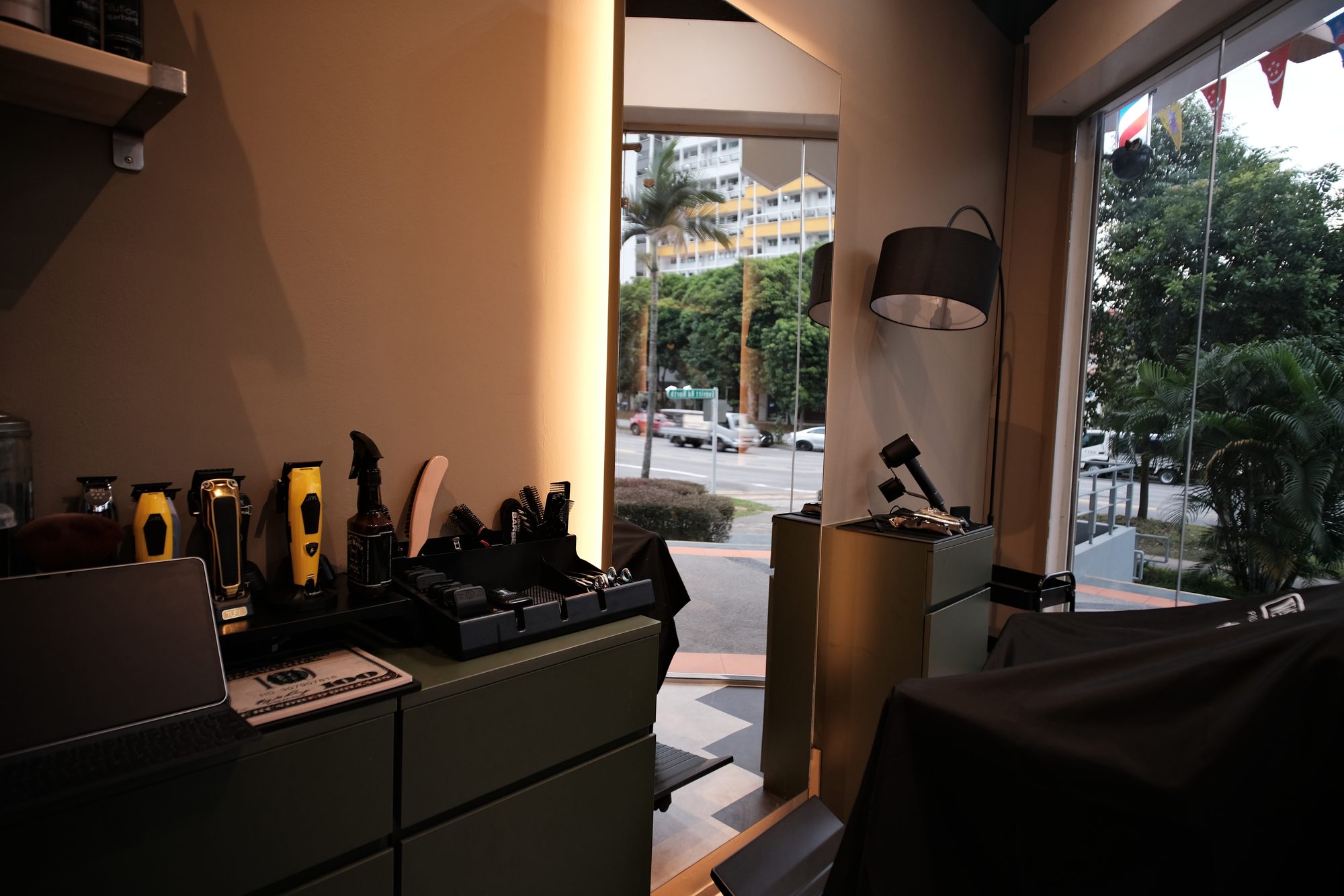 Styling station with warm lighting and arc lamp in a small shared retail space Singapore